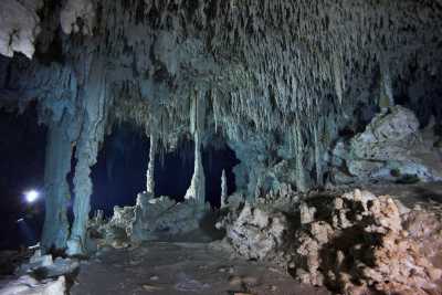 Stalactites and stalagmites in the large cavern of the Toh Ha cave system